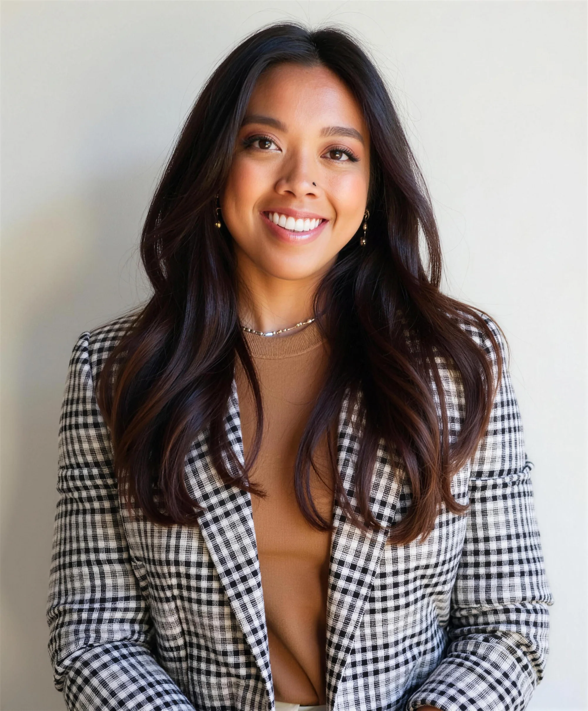 Portrait of Dr. Lexi Gonzales in a houndstooth blazer