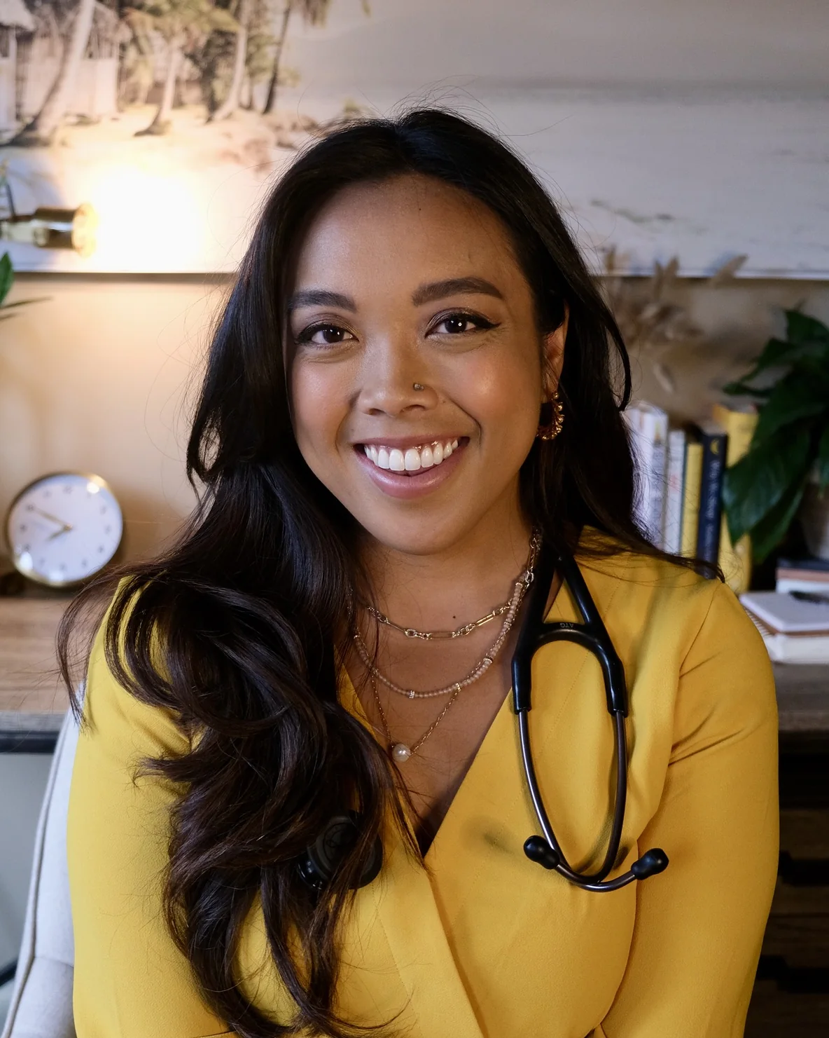 Dr. Lexi Gonzales in a yellow top with a stethoscope around her neck